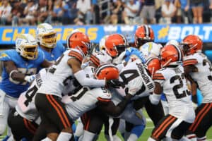 The Cleveland Browns defense pushes Austin Ekeler #30 of the Los Angeles Chargers into the endzone for a Chargers touchdown during the fourth quarter at SoFi Stadium on October 10, 2021 in Inglewood, California.