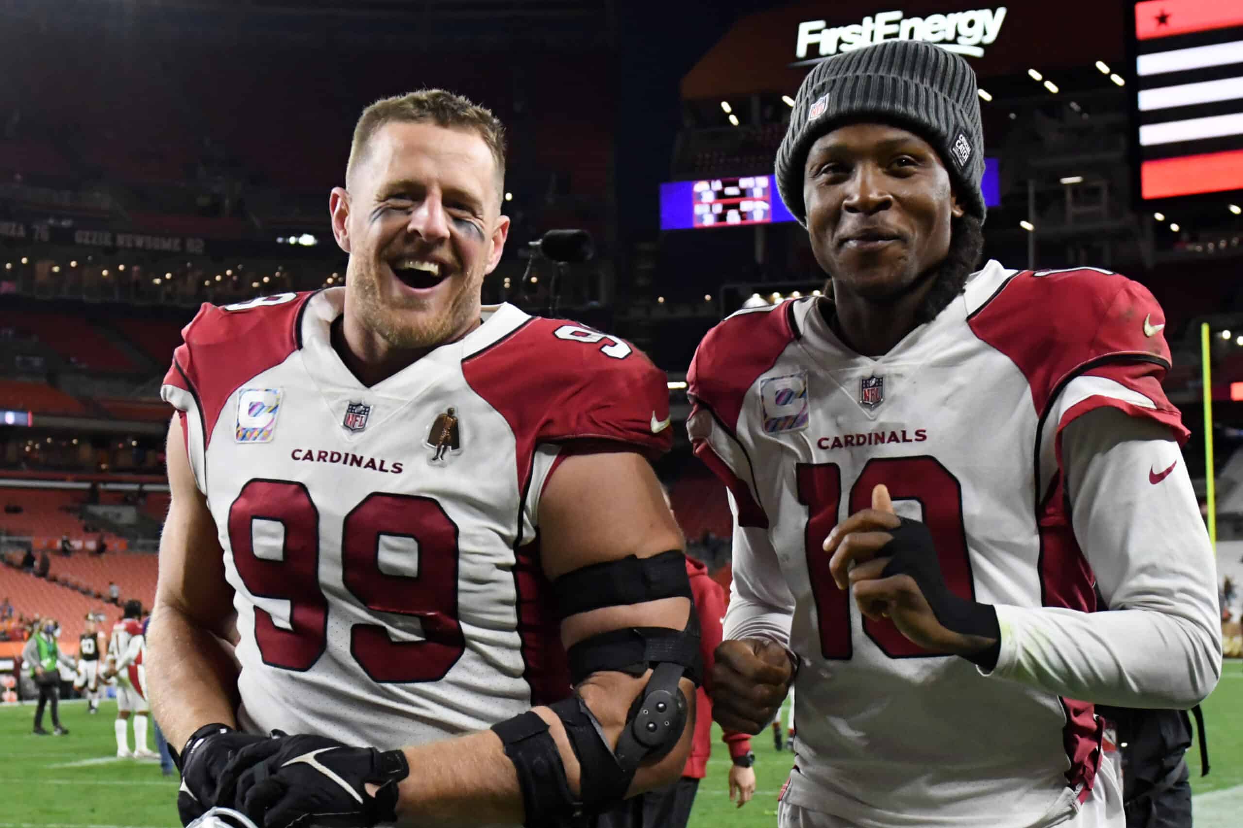 J.J. Watt #99 and DeAndre Hopkins #10 of the Arizona Cardinals react after a 37-14 win against the Cleveland Browns at FirstEnergy Stadium on October 17, 2021 in Cleveland, Ohio. 