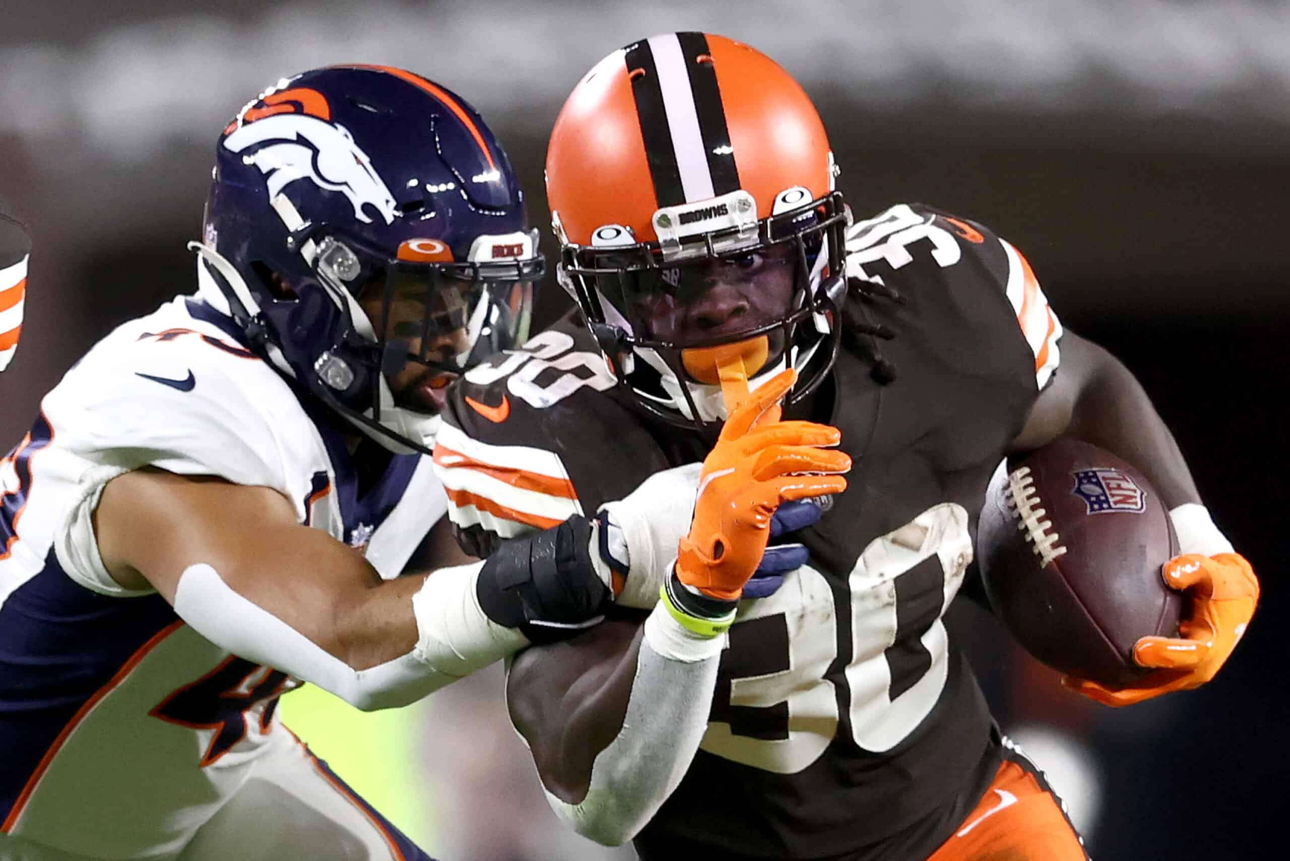 Inside linebacker Justin Strnad #40 of the Denver Broncos tackles running back D'Ernest Johnson #30 of the Cleveland Browns in the first half at FirstEnergy Stadium on October 21, 2021 in Cleveland, Ohio.