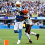 Keenan Allen #13 of the Los Angeles Chargers is tackled by Greedy Williams #26 of the Cleveland Browns after his catch during a 47-42 win over the Cleveland Browns at SoFi Stadium on October 10, 2021 in Inglewood, California.