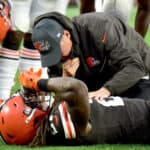 Kareem Hunt #27 of the Cleveland Browns is tended to by team medical personnel after an injury during the fourth quarter against the Arizona Cardinals at FirstEnergy Stadium on October 17, 2021 in Cleveland, Ohio.