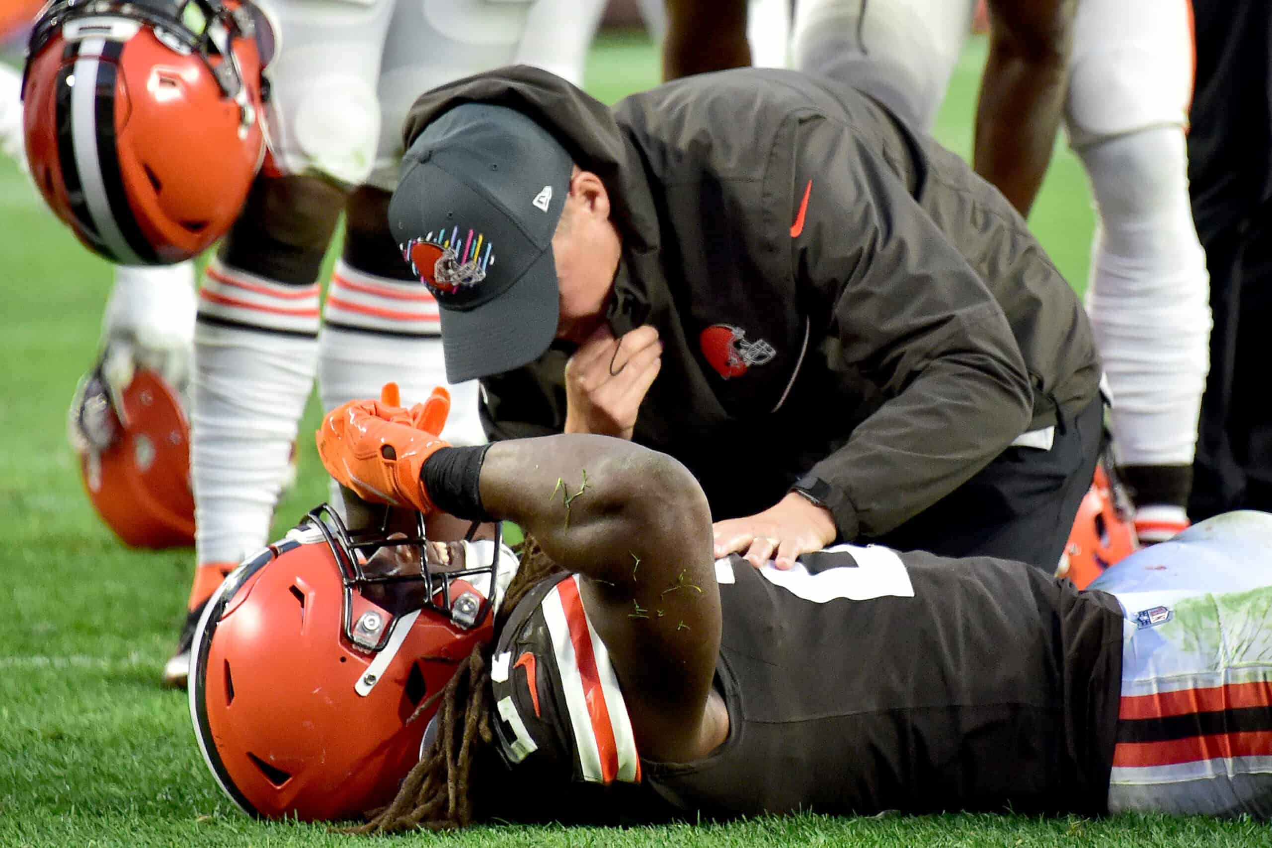 Kareem Hunt #27 of the Cleveland Browns is tended to by team medical personnel after an injury during the fourth quarter against the Arizona Cardinals at FirstEnergy Stadium on October 17, 2021 in Cleveland, Ohio. 