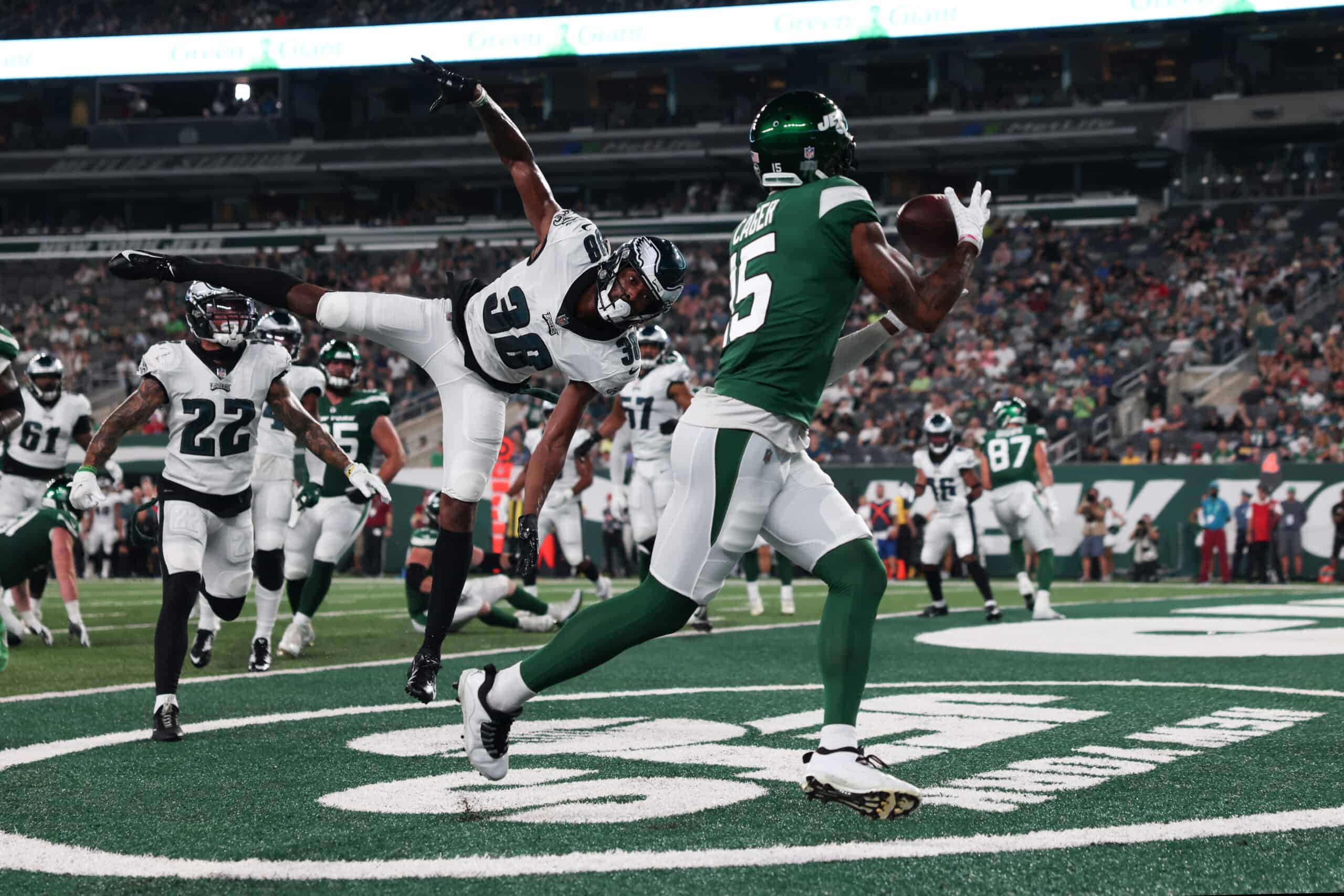 Lawrence Cager #15 of the New York Jets catches a touchdown pass over Michael Jacquet #38 of the Philadelphia Eagles during the first quarter of a preseason game at MetLife Stadium on August 27, 2021 in East Rutherford, New Jersey.