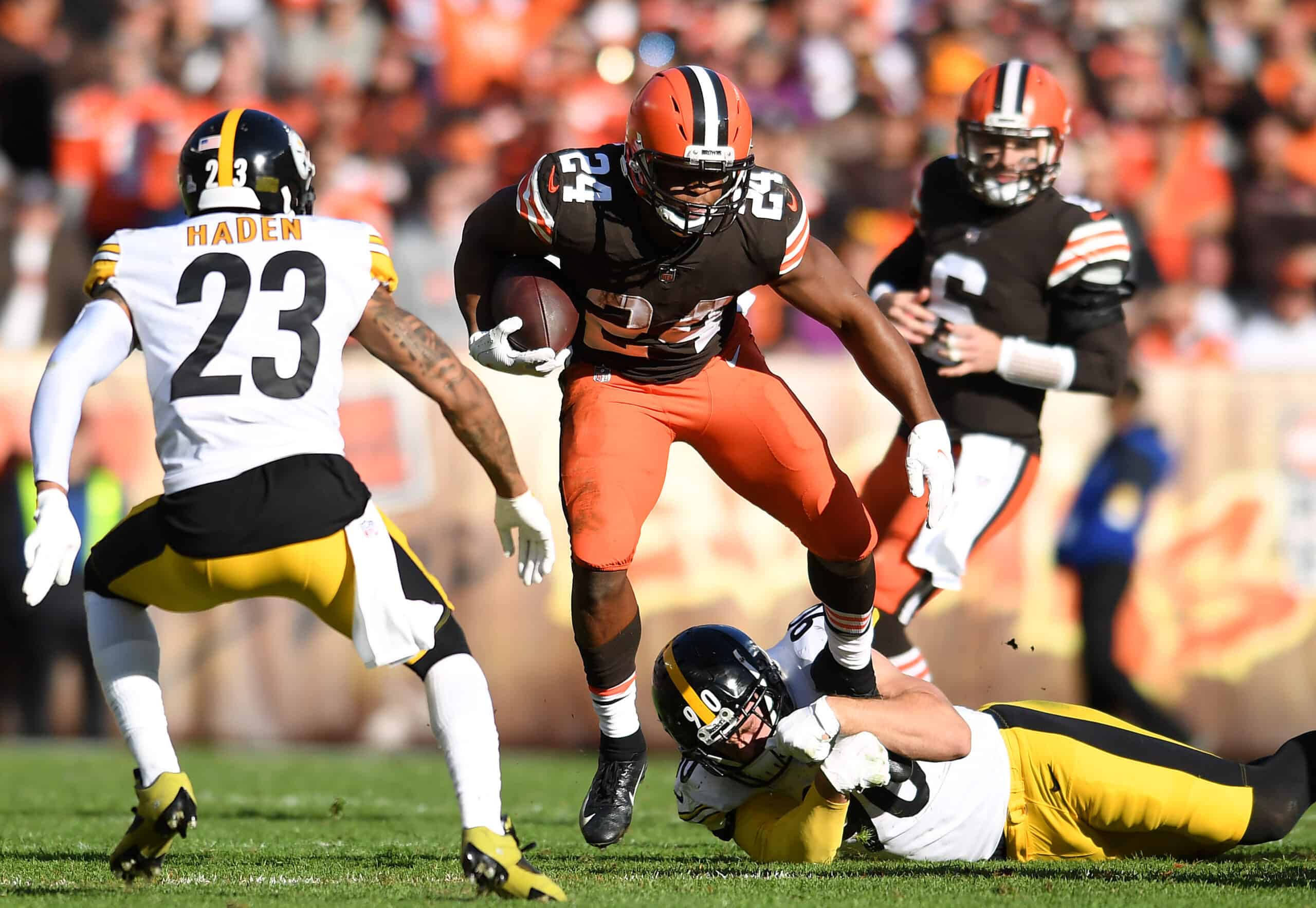 Nick Chubb #24 of the Cleveland Browns avoids the tackle by T.J. Watt #90 of the Pittsburgh Steelers in the second half at FirstEnergy Stadium on October 31, 2021 in Cleveland, Ohio.