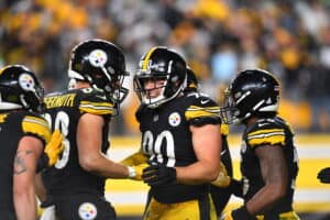 T.J. Watt #90 of the Pittsburgh Steelers reacts following a fumble alongside Pat Freiermuth #88 of the Pittsburgh Steelers in overtime against the Seattle Seahawks at Heinz Field on October 17, 2021 in Pittsburgh, Pennsylvania.