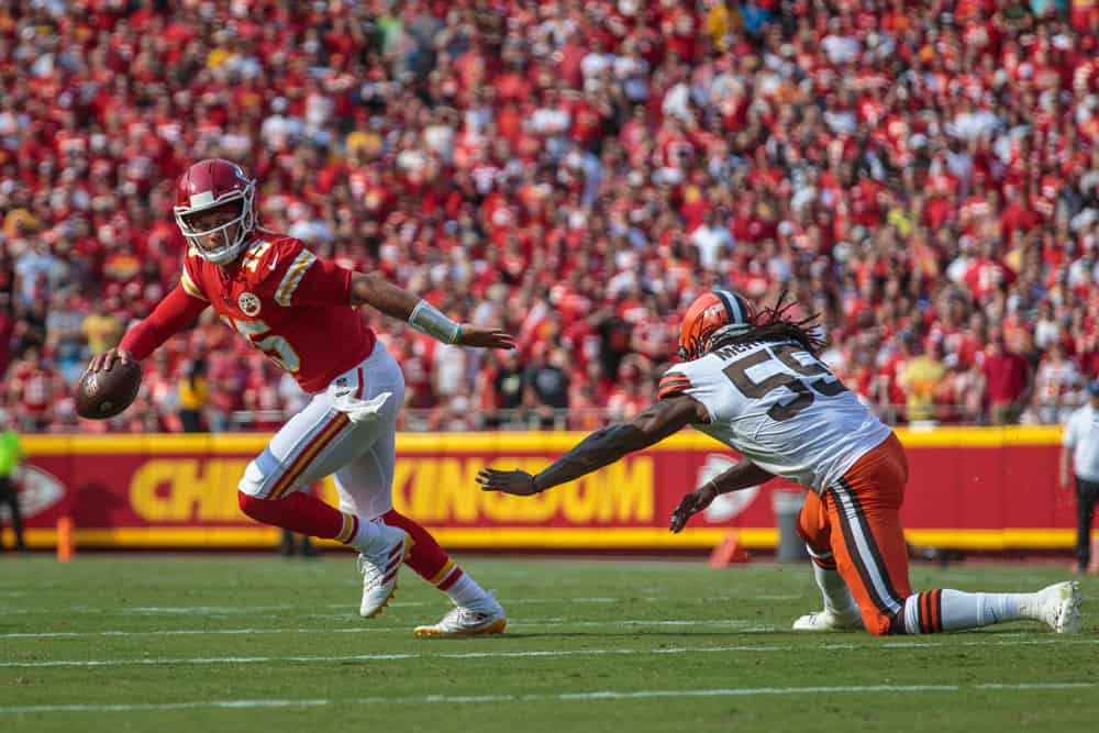 Kansas City Chiefs quarterback Patrick Mahomes (15) scrambles in the back field from Cleveland Browns defensive end Takkarist McKinley (55) on September 12th at GEHA field at Arrowhead Stadium in Kansas City, Missouri.