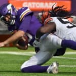 Kirk Cousins #8 of the Minnesota Vikings is tackled by Takkarist McKinley #55 of the Cleveland Browns at U.S. Bank Stadium on October 03, 2021 in Minneapolis, Minnesota.