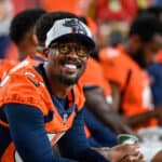 Von Miller #58 of the Denver Broncos looks on in the bench area during an NFL preseason game against the Los Angeles Rams at Empower Field at Mile High on August 28, 2021 in Denver, Colorado.