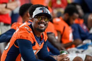 Von Miller #58 of the Denver Broncos looks on in the bench area during an NFL preseason game against the Los Angeles Rams at Empower Field at Mile High on August 28, 2021 in Denver, Colorado.