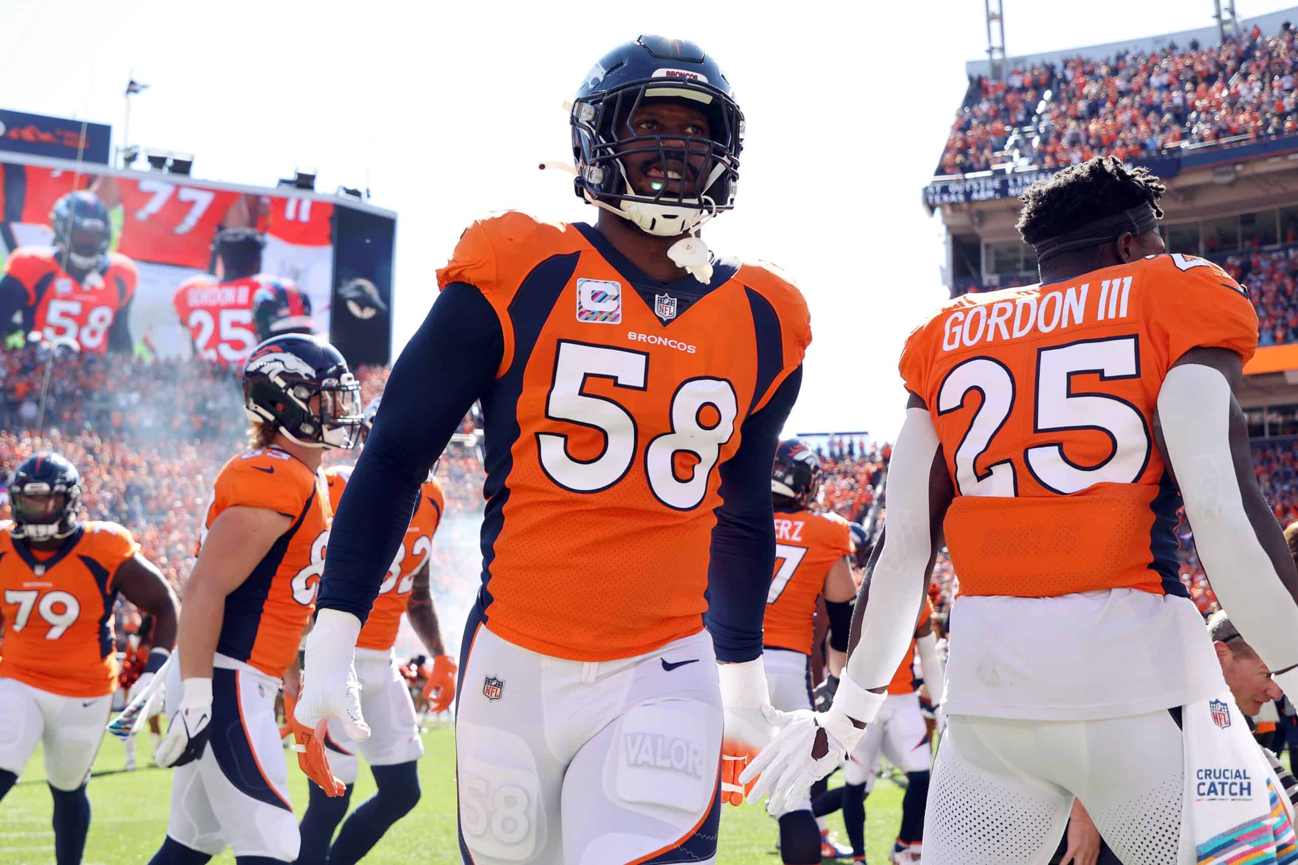 Von Miller #58 of the Denver Broncos takes the field with teammates before the game against the Baltimore Ravens at Empower Field At Mile High on October 03, 2021 in Denver, Colorado.