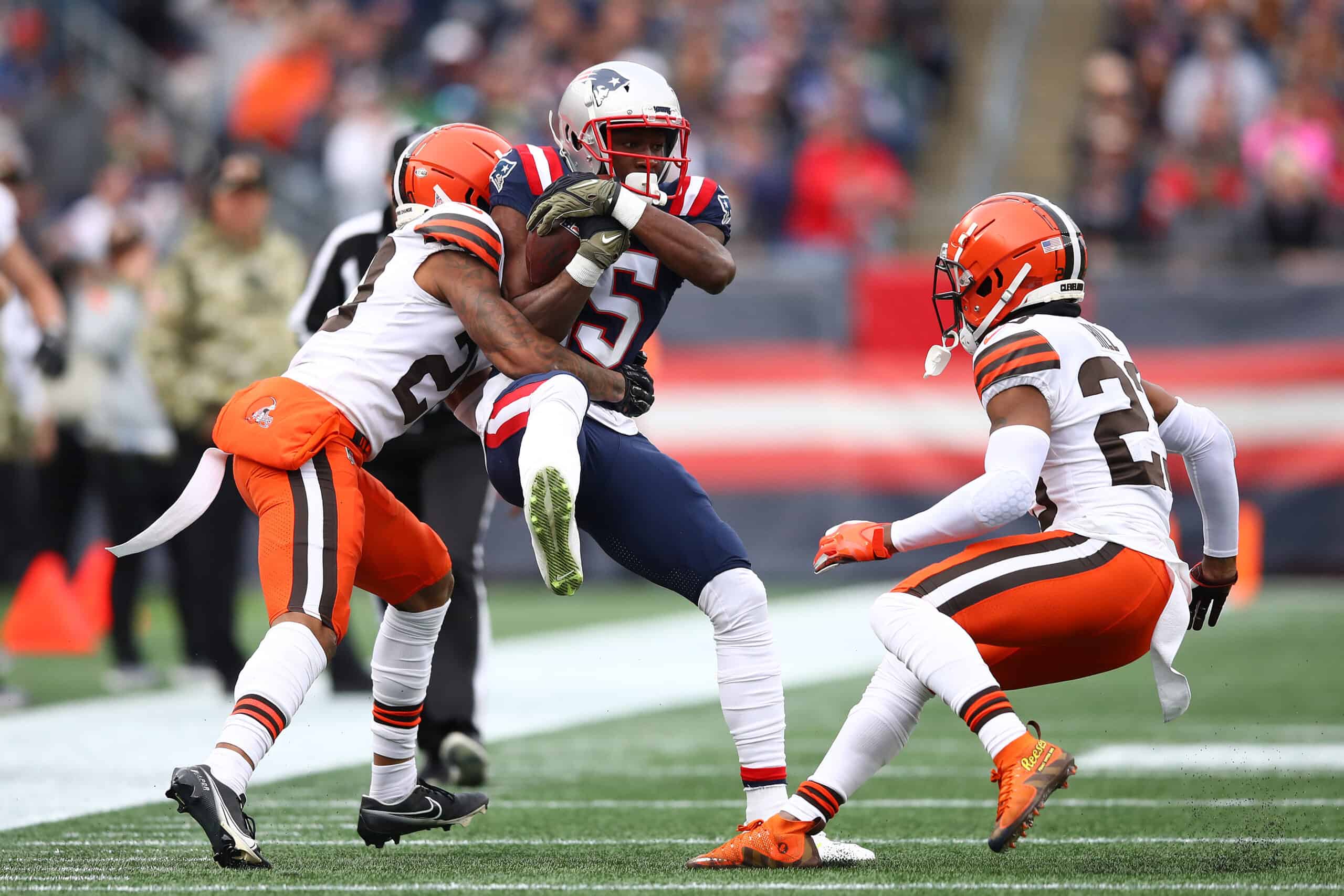 Nelson Agholor #15 of the New England Patriots is tackled by Greg Newsome II #20 of the Cleveland Browns during the first quarter at Gillette Stadium on November 14, 2021 in Foxborough, Massachusetts. 