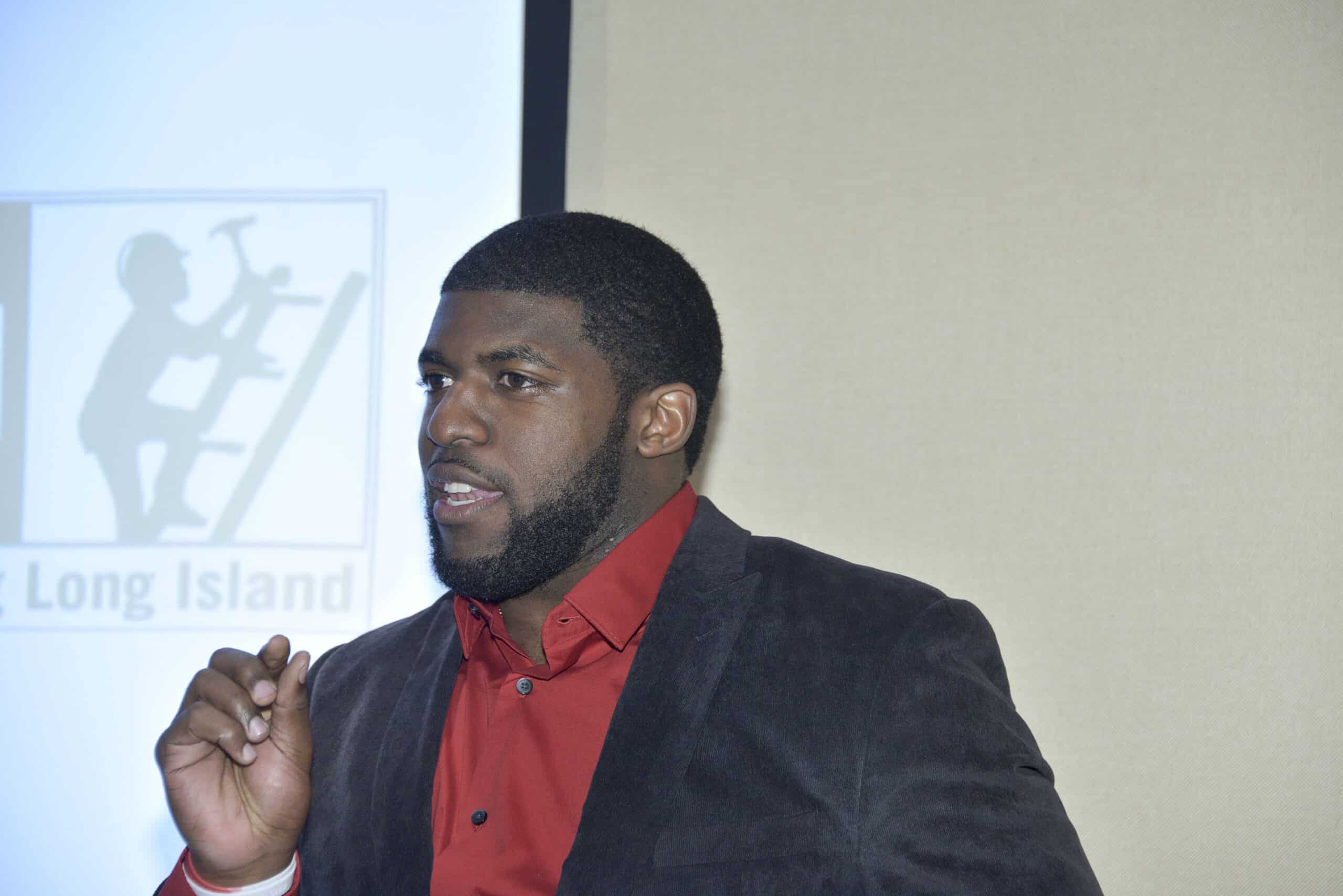 NFL Linebacker Emmanuel Acho Visits United Way Of Long Island and Youth Build Program on March 4, 2015 in Deer Park, New York. 