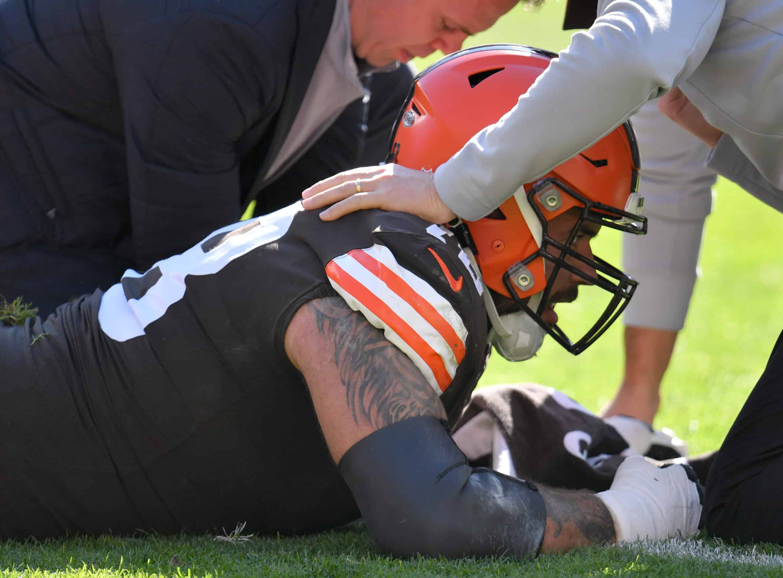 Jack Conklin #78 of the Cleveland Browns talks to medical staff after an injury during the first half against the Pittsburgh Steelers at FirstEnergy Stadium on October 31, 2021 in Cleveland, Ohio.