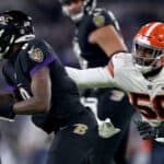 Malik McDowell #58 of the Cleveland Browns pressures Lamar Jackson #8 of the Baltimore Ravens during a game at M&T Bank Stadium on November 28, 2021 in Baltimore, Maryland.