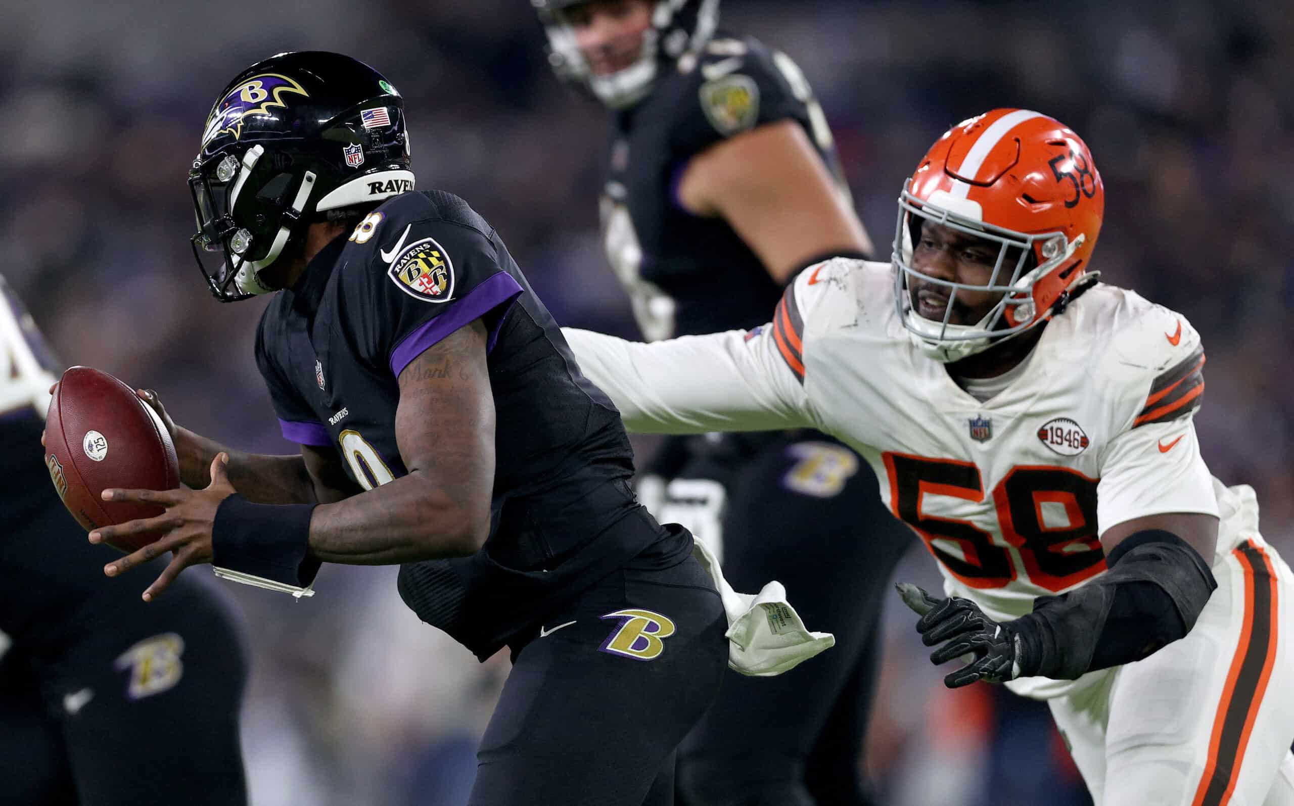 Malik McDowell #58 of the Cleveland Browns pressures Lamar Jackson #8 of the Baltimore Ravens during a game at M&T Bank Stadium on November 28, 2021 in Baltimore, Maryland. 