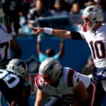 Mac Jones #10 of the New England Patriots calls a play at the line during the first quarter against the Carolina Panthers at Bank of America Stadium on November 07, 2021 in Charlotte, North Carolina.