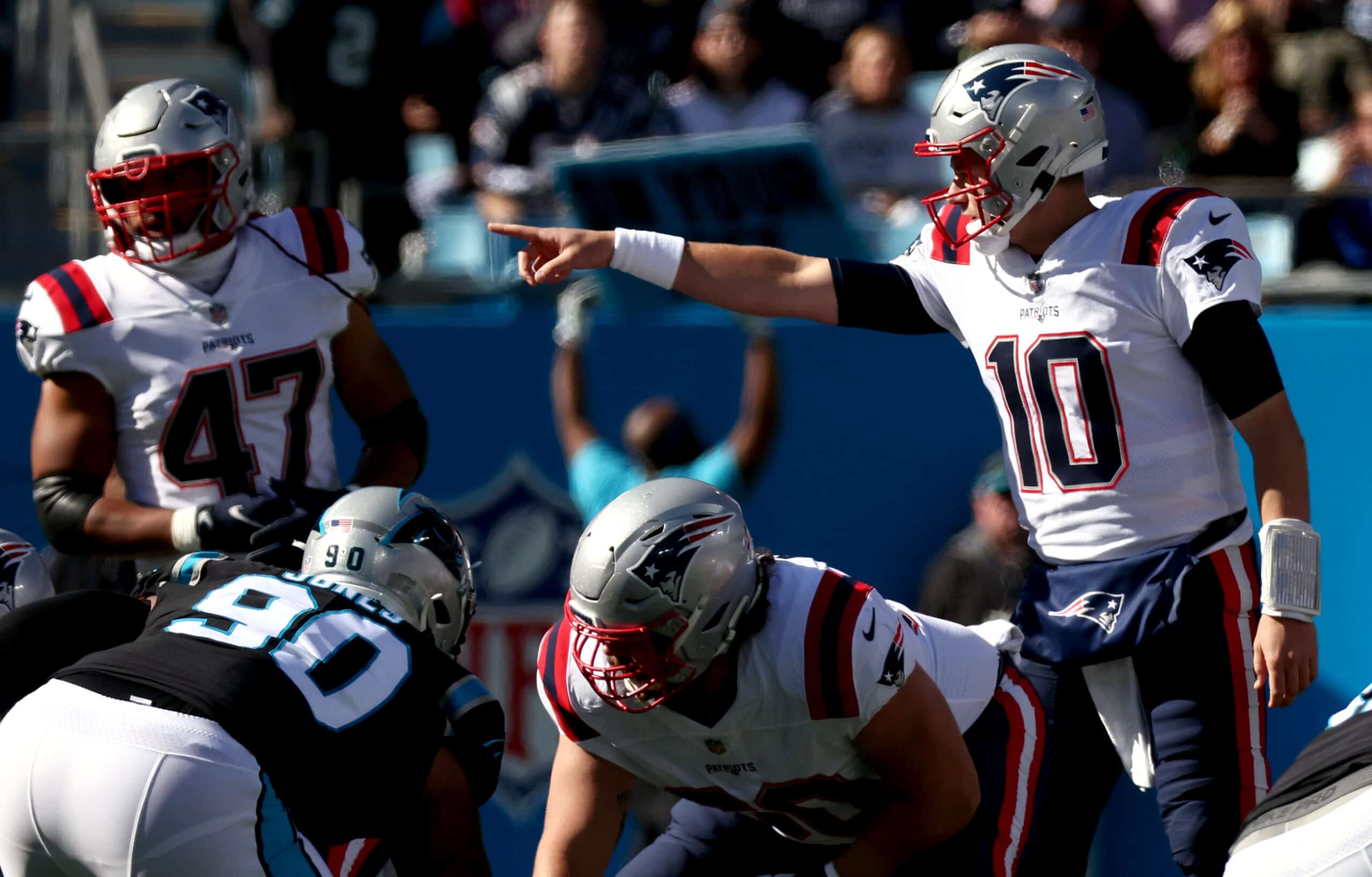 Mac Jones #10 of the New England Patriots calls a play at the line during the first quarter against the Carolina Panthers at Bank of America Stadium on November 07, 2021 in Charlotte, North Carolina.