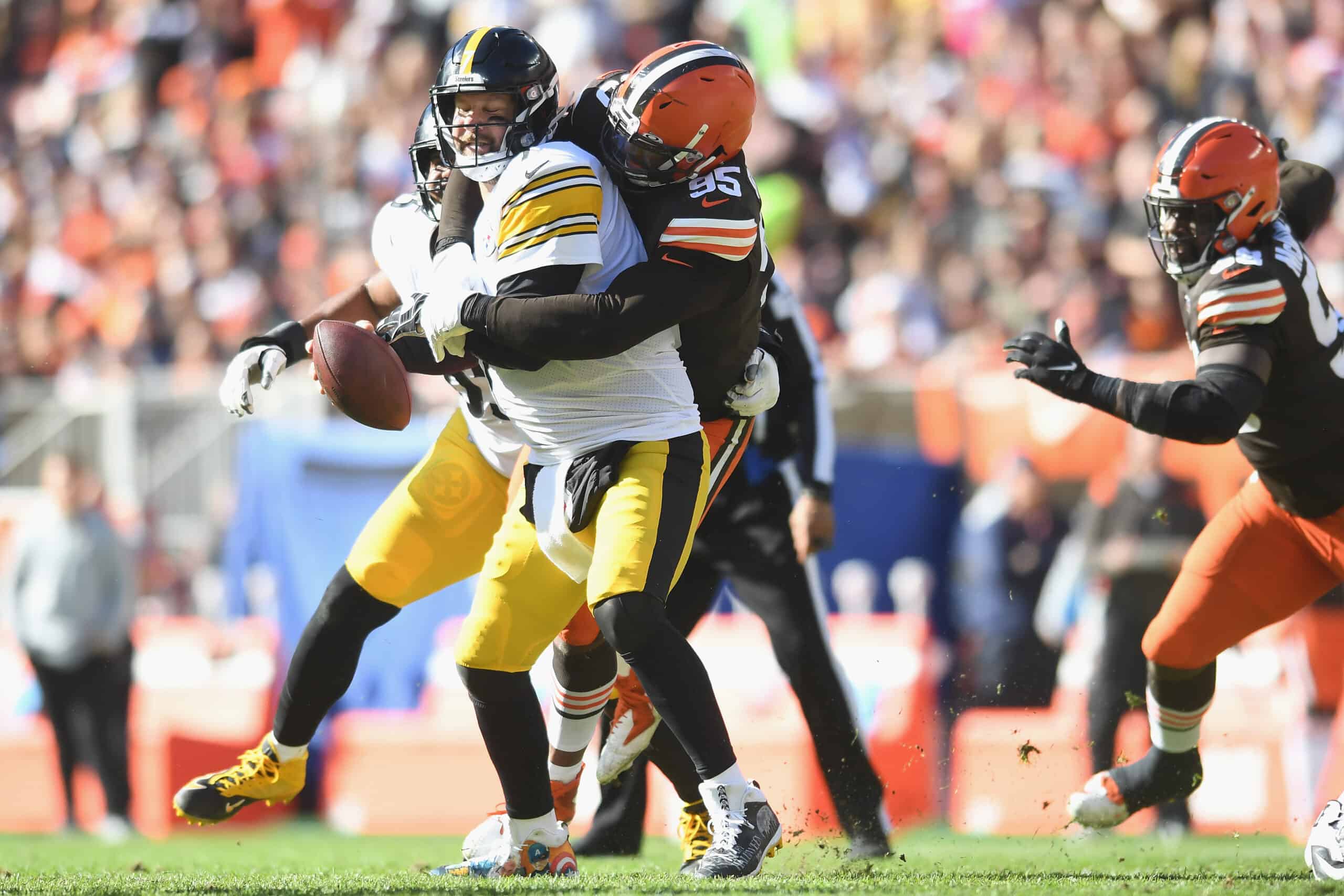 Myles Garrett #95 of the Cleveland Browns sacks Ben Roethlisberger #7 of the Pittsburgh Steelers during the first half at FirstEnergy Stadium on October 31, 2021 in Cleveland, Ohio. 