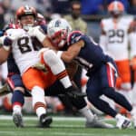 Austin Hooper #81 of the Cleveland Browns is tackled by Dont'a Hightower #54 and Myles Bryant #41 of the New England Patriots during the third quarter at Gillette Stadium on November 14, 2021 in Foxborough, Massachusetts.