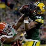 Davante Adams #17 of the Green Bay Packers makes a catch for a touchdown while being guarded by M.J. Stewart Jr. #36 of the Cleveland Browns in the second quarter at Lambeau Field on December 25, 2021 in Green Bay, Wisconsin.