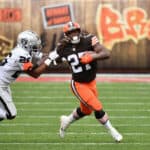 Running back Kareem Hunt #27 of the Cleveland Browns rushes the football past cornerback Nevin Lawson #26 of the Las Vegas Raiders during the first half of the NFL game at FirstEnergy Stadium on November 01, 2020 in Cleveland, Ohio.