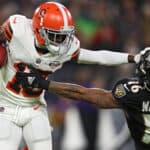 JoJo Natson #19 of the Cleveland Browns stiff arms Tylan Wallace #16 of the Baltimore Ravens during the first half at M&T Bank Stadium on November 28, 2021 in Baltimore, Maryland.