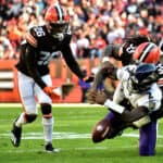 Takkarist McKinley #55 of the Cleveland Browns strips the ball loose from Tyler Huntley #2 of the Baltimore Ravens for a fumble during the third quarter at FirstEnergy Stadium on December 12, 2021 in Cleveland, Ohio.
