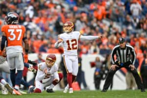 Washington Football Team kicker Chris Blewitt (12) kicks a field goal during a game between the Denver Broncos and the Washington Football Team at Empower Field at Mile High on October 31, 2021 in Denver, Colorado.