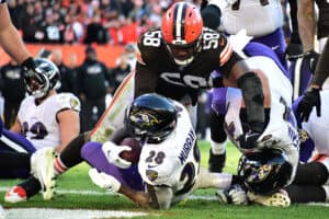 Latavius Murray #28 of the Baltimore Ravens falls into the end zone for a rushing touchdown against Malik McDowell #58 of the Cleveland Browns during the fourth quarter at FirstEnergy Stadium on December 12, 2021 in Cleveland, Ohio.