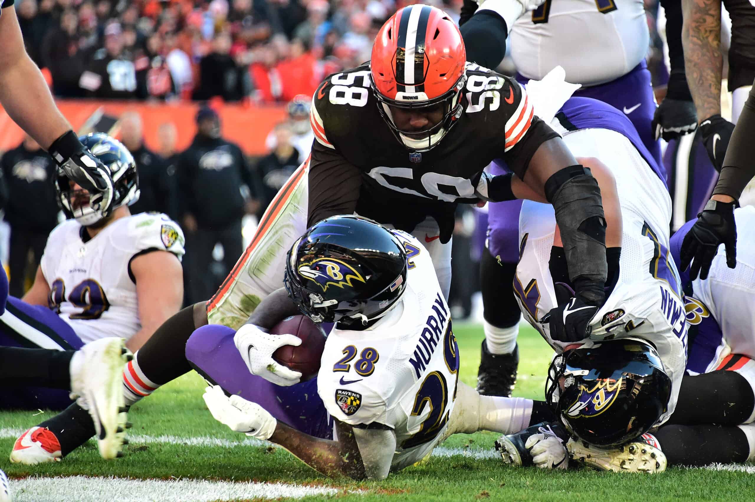 Latavius Murray #28 of the Baltimore Ravens falls into the end zone for a rushing touchdown against Malik McDowell #58 of the Cleveland Browns during the fourth quarter at FirstEnergy Stadium on December 12, 2021 in Cleveland, Ohio. 