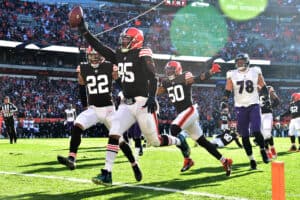 Myles Garrett #95 of the Cleveland Browns runs the ball into the end zone for a touchdown after a fumble recovery in the second quarter against the Baltimore Ravens at FirstEnergy Stadium on December 12, 2021 in Cleveland, Ohio.