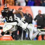 Nick Chubb #24 of the Cleveland Browns is tackled by Johnathan Abram #24 of the Las Vegas Raiders in the second half of the game at FirstEnergy Stadium on December 20, 2021 in Cleveland, Ohio.