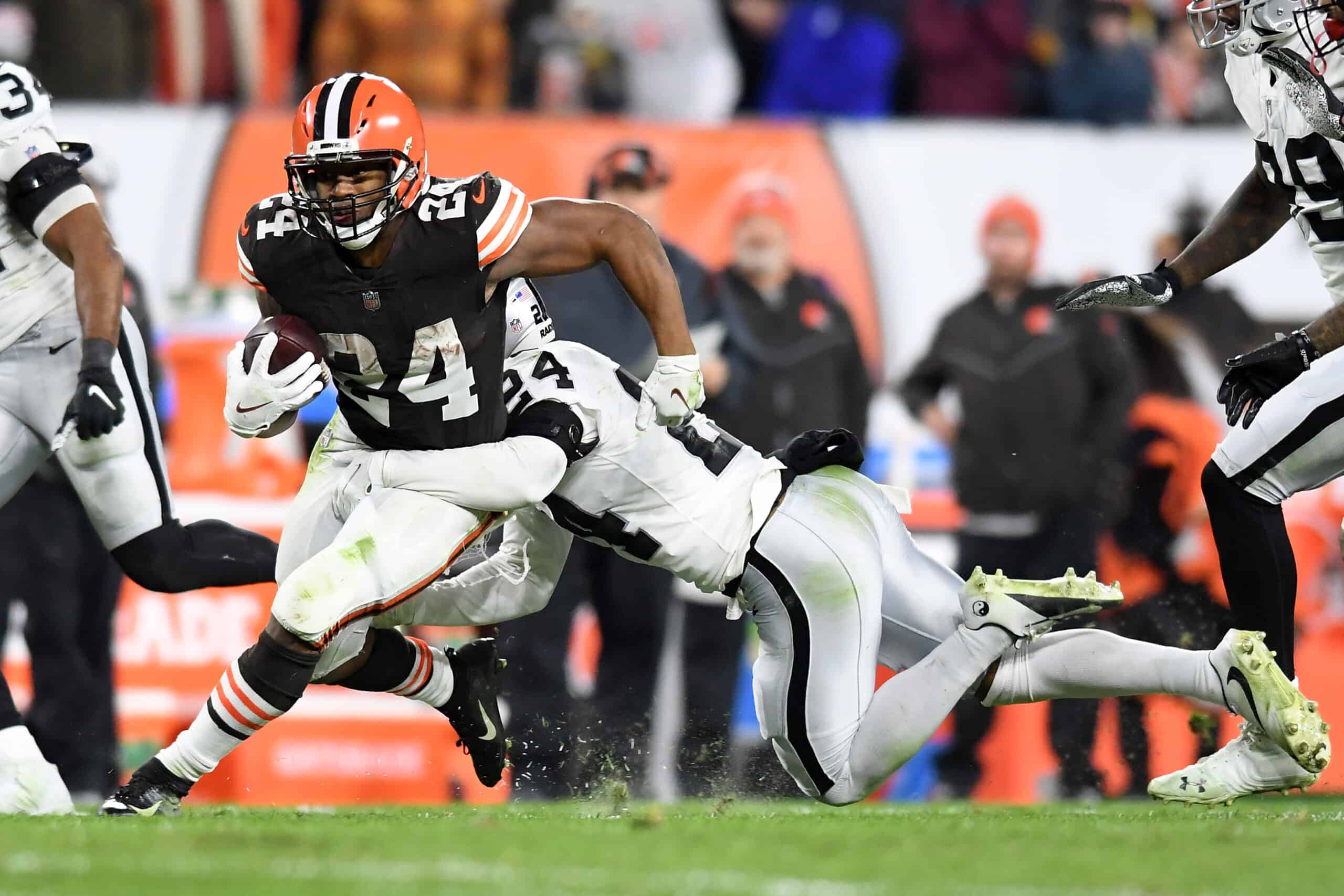 Nick Chubb #24 of the Cleveland Browns is tackled by Johnathan Abram #24 of the Las Vegas Raiders in the second half of the game at FirstEnergy Stadium on December 20, 2021 in Cleveland, Ohio.