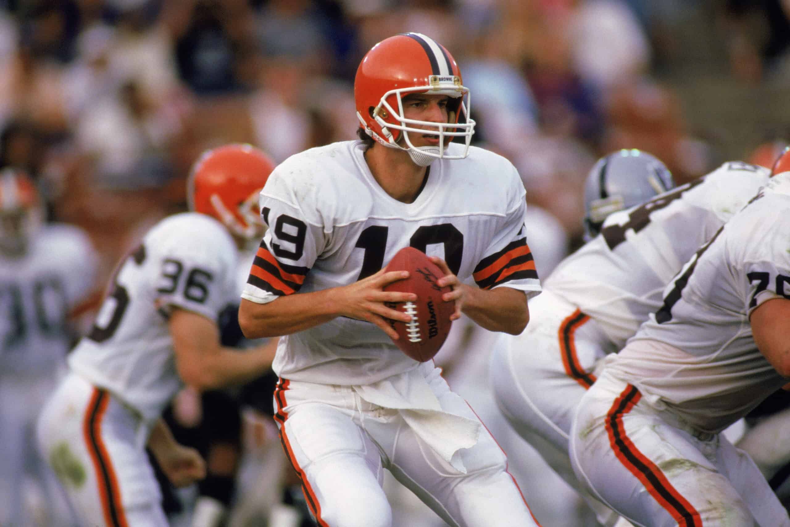 Bernie Kosar #19 of the Cleveland Browns looks for a receiver during a 1988 NFL game