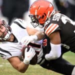 Trent Taylor #11 of the Cincinnati Bengals is hit by M.J. Stewart #36 of the Cleveland Browns during the second half at FirstEnergy Stadium on January 09, 2022 in Cleveland, Ohio.