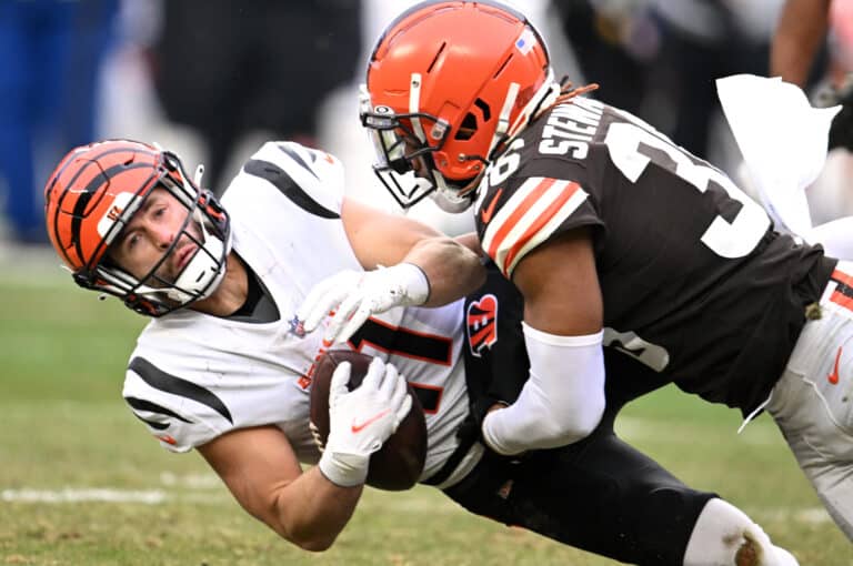 Trent Taylor #11 of the Cincinnati Bengals is hit by M.J. Stewart #36 of the Cleveland Browns during the second half at FirstEnergy Stadium on January 09, 2022 in Cleveland, Ohio.