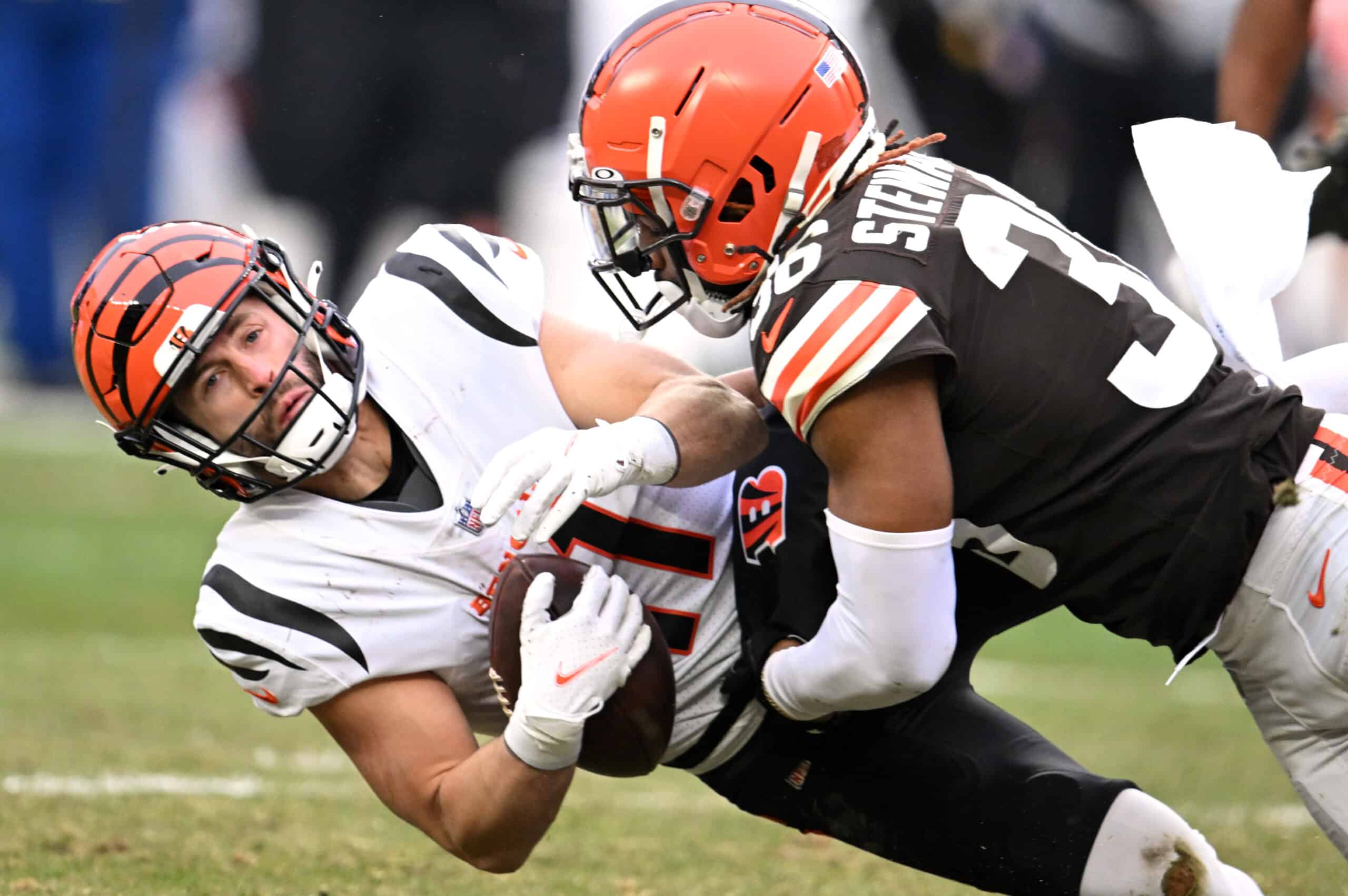 Trent Taylor #11 of the Cincinnati Bengals is hit by M.J. Stewart #36 of the Cleveland Browns during the second half at FirstEnergy Stadium on January 09, 2022 in Cleveland, Ohio.