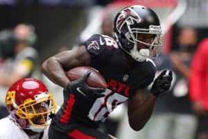 Calvin Ridley #18 of the Atlanta Falcons runs with the ball after the catch against Kendall Fuller #29 of the Washington Football Team in the first quarter at Mercedes-Benz Stadium on October 03, 2021 in Atlanta, Georgia.