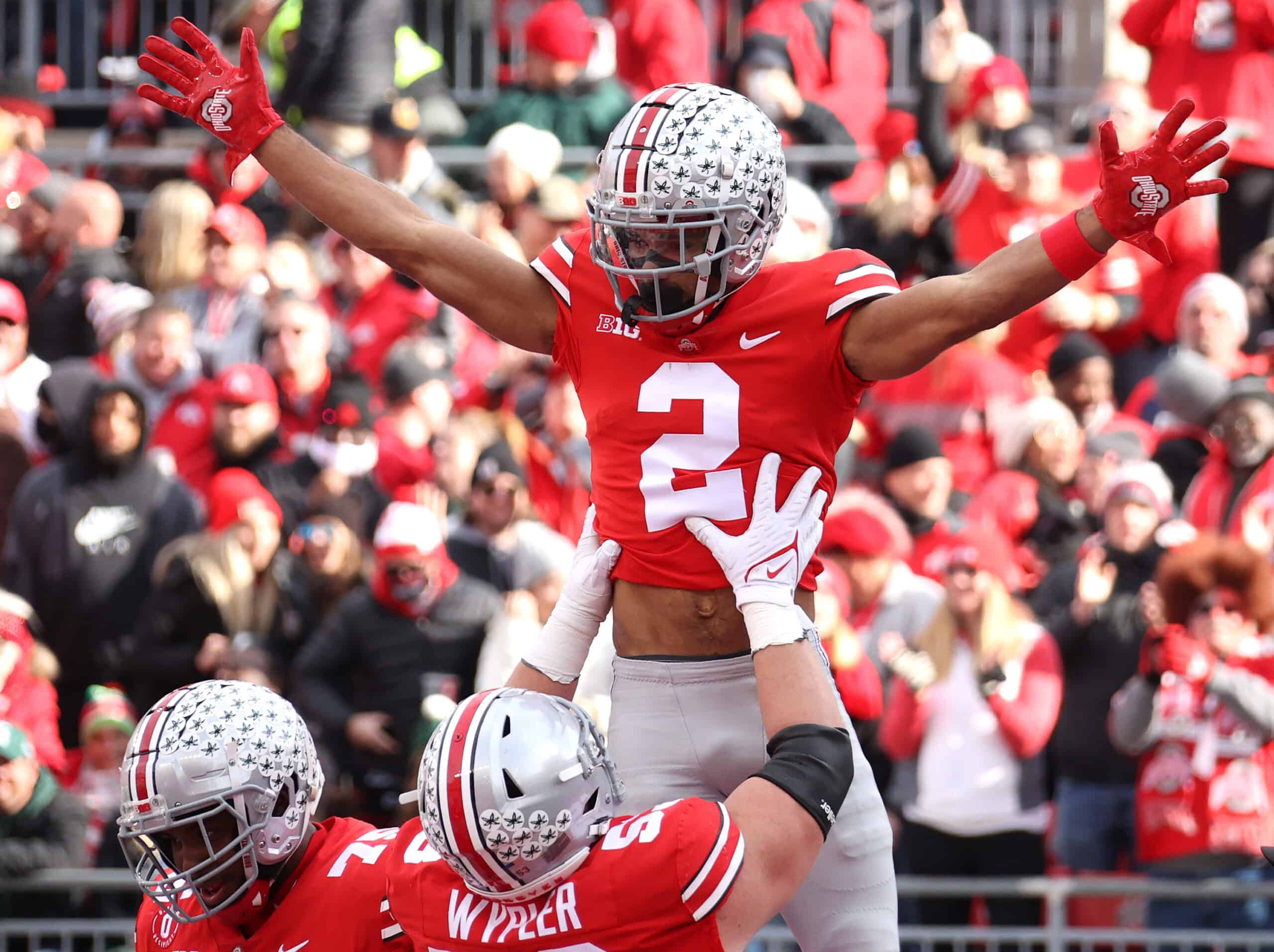 Chris Olave #2 of the Ohio State Buckeyes celebrates a first half touchdown catch against the Michigan State Spartans with Luke Wypler #53 of the Ohio State Buckeyes at Ohio Stadium on November 20, 2021 in Columbus, Ohio. 