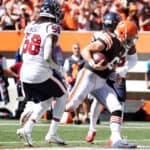 Quarterback Baker Mayfield #6 of the Cleveland Browns runs the ball passed outside linebacker Christian Kirksey #58 of the Houston Texans for a touchdown at FirstEnergy Stadium on September 19, 2021 in Cleveland, Ohio.