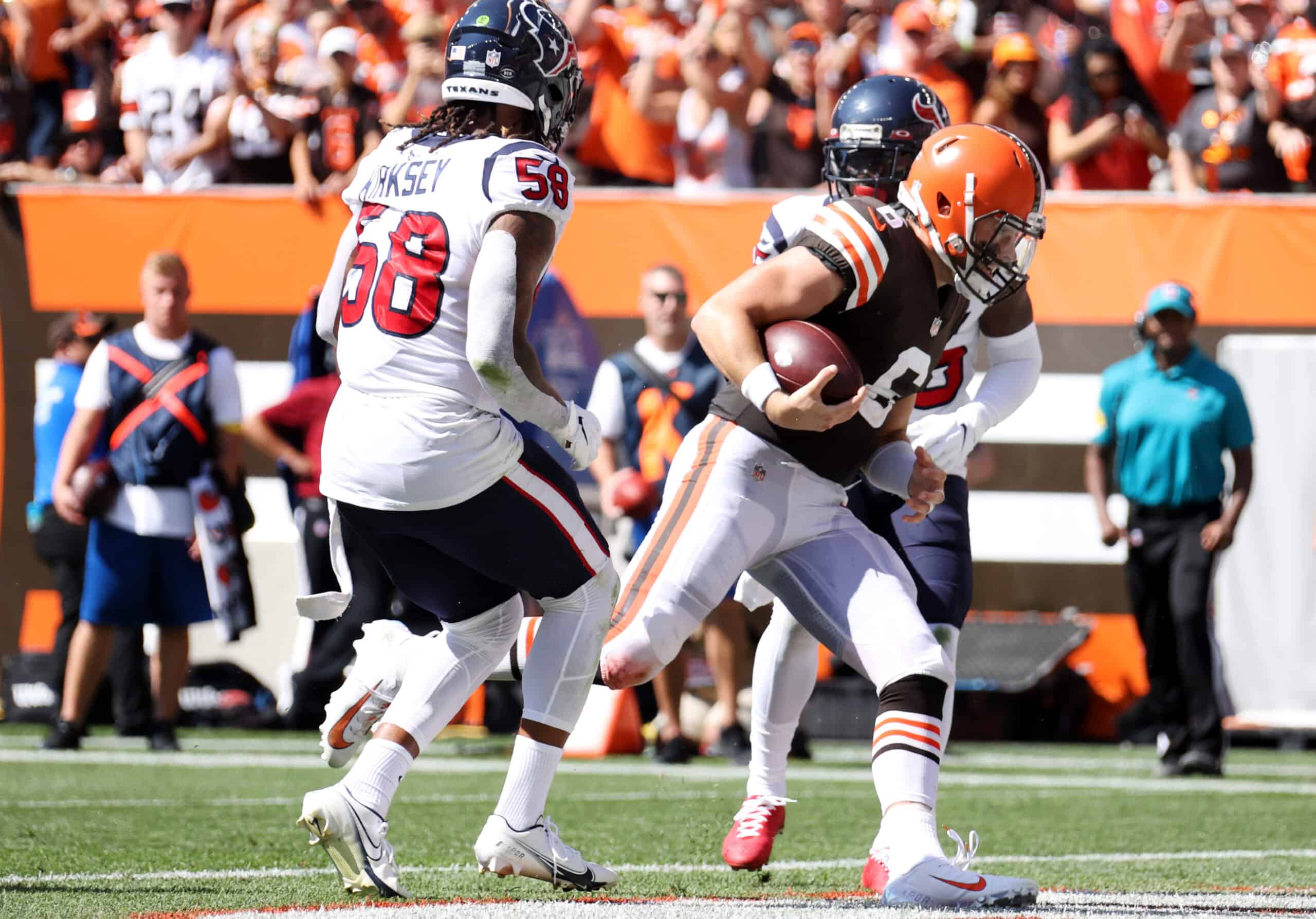 Quarterback Baker Mayfield #6 of the Cleveland Browns runs the ball passed outside linebacker Christian Kirksey #58 of the Houston Texans for a touchdown at FirstEnergy Stadium on September 19, 2021 in Cleveland, Ohio.