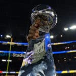 The Vince Lombardi Trophy is held in the air after Super Bowl LVI at SoFi Stadium on February 13, 2022 in Inglewood, California. The Los Angeles Rams defeated the Cincinnati Bengals 23-20.