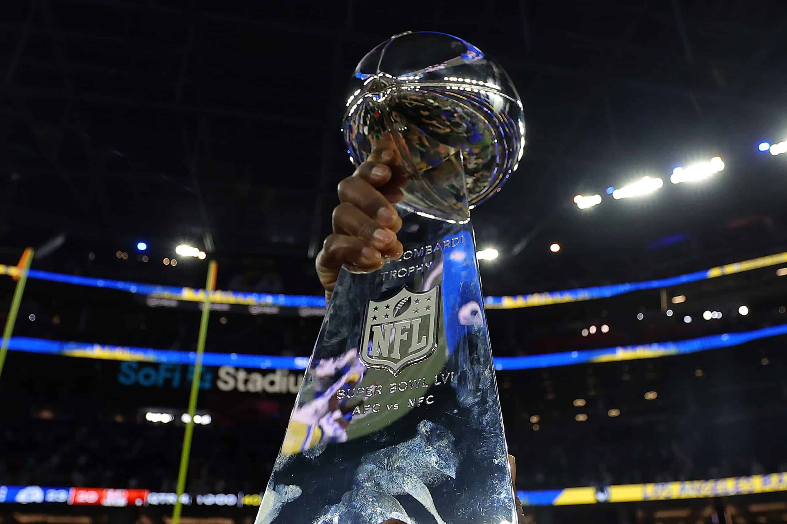 The Vince Lombardi Trophy is held in the air after Super Bowl LVI at SoFi Stadium on February 13, 2022 in Inglewood, California. The Los Angeles Rams defeated the Cincinnati Bengals 23-20.