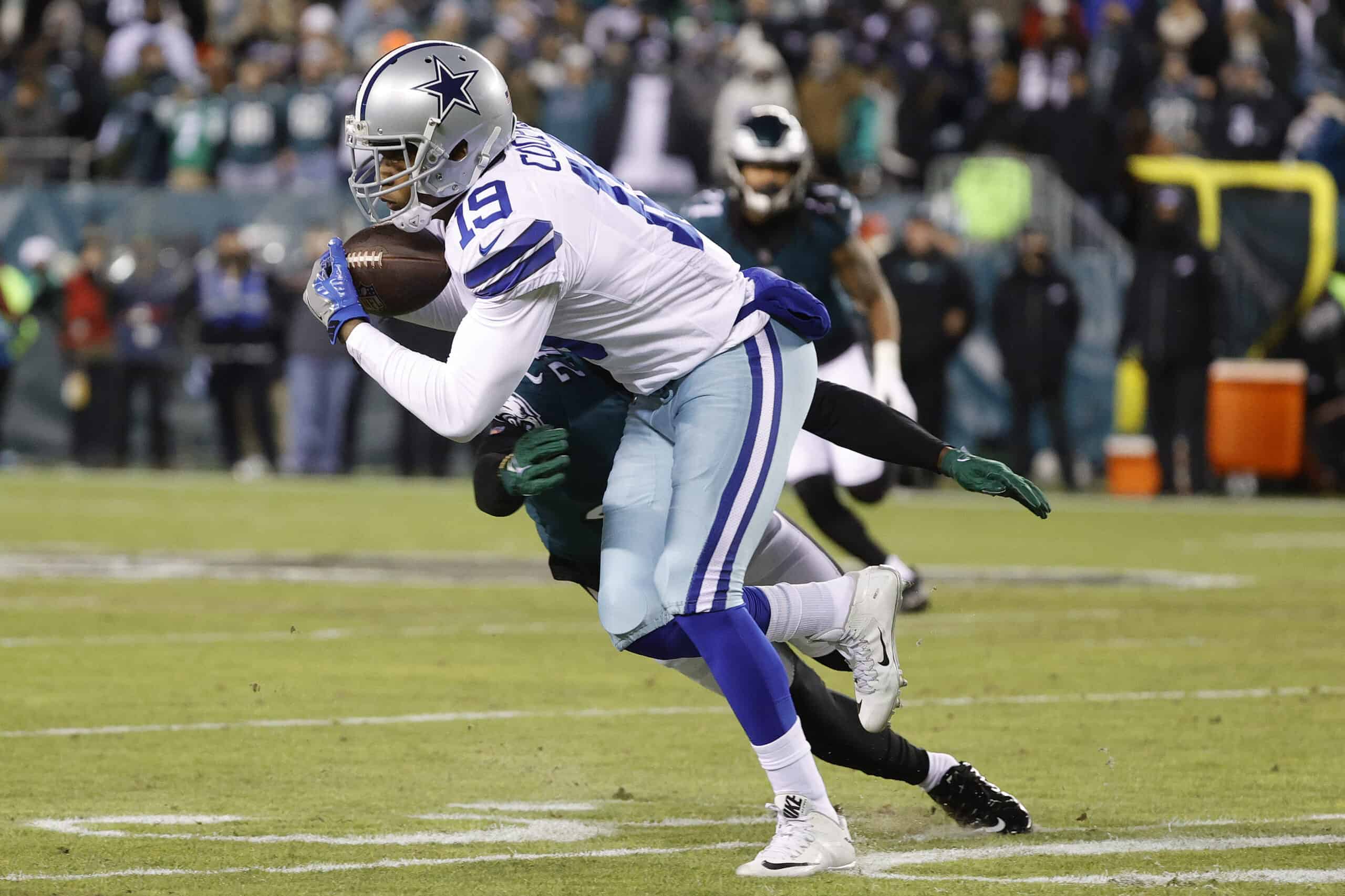 Amari Cooper #19 of the Dallas Cowboys makes a reception past K'Von Wallace #42 of the Philadelphia Eagles at Lincoln Financial Field on January 08, 2022 in Philadelphia, Pennsylvania.