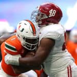 D'Eriq King #1 of the Miami Hurricanes is tackled by Phidarian Mathis #48 of the Alabama Crimson Tide during the second half of the Chick-fil-A Kick-Off Game at Mercedes-Benz Stadium on September 04, 2021 in Atlanta, Georgia.
