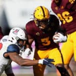 Running back Rachaad White #3 of the Arizona State Sun Devils rushes the football against linebacker Malik Reed #53 of the Arizona Wildcats during the first quarter of the Territorial Cup game at Sun Devil Stadium on November 27, 2021 in Tempe, Arizona.