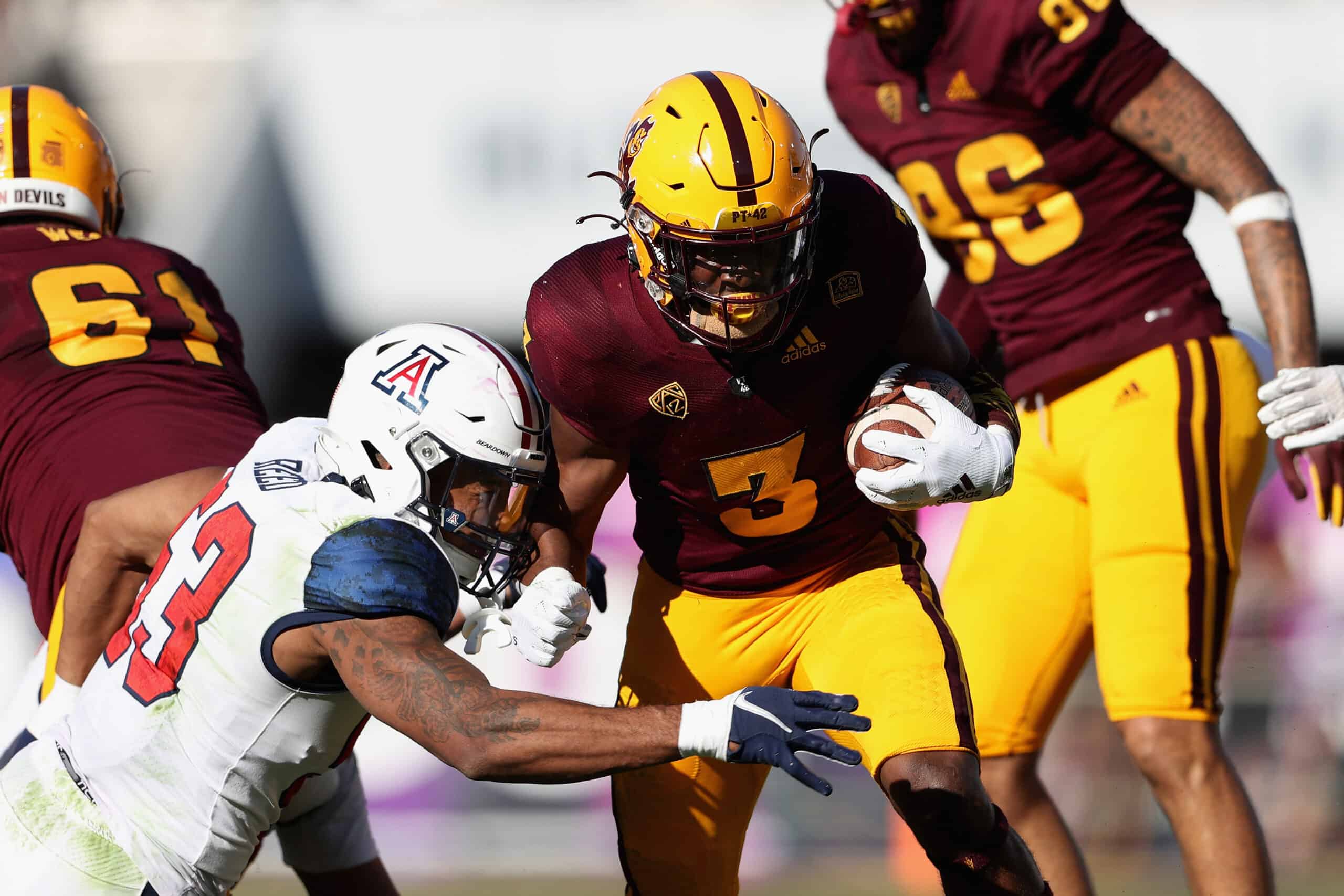 Running back Rachaad White #3 of the Arizona State Sun Devils rushes the football against linebacker Malik Reed #53 of the Arizona Wildcats during the first quarter of the Territorial Cup game at Sun Devil Stadium on November 27, 2021 in Tempe, Arizona.