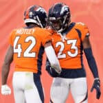 Michael Ojemudia #23 of the Denver Broncos celebrates with Parnell Motley #42 after recovering a fumble against the Las Vegas Raiders in the second quarter at Empower Field At Mile High on January 03, 2021 in Denver, Colorado.