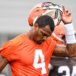 Deshaun Watson #4 of the Cleveland Browns takes off his helmet as he warms up during the Cleveland Browns mandatory minicamp at CrossCountry Mortgage Campus on June 14, 2022 in Berea, Ohio.