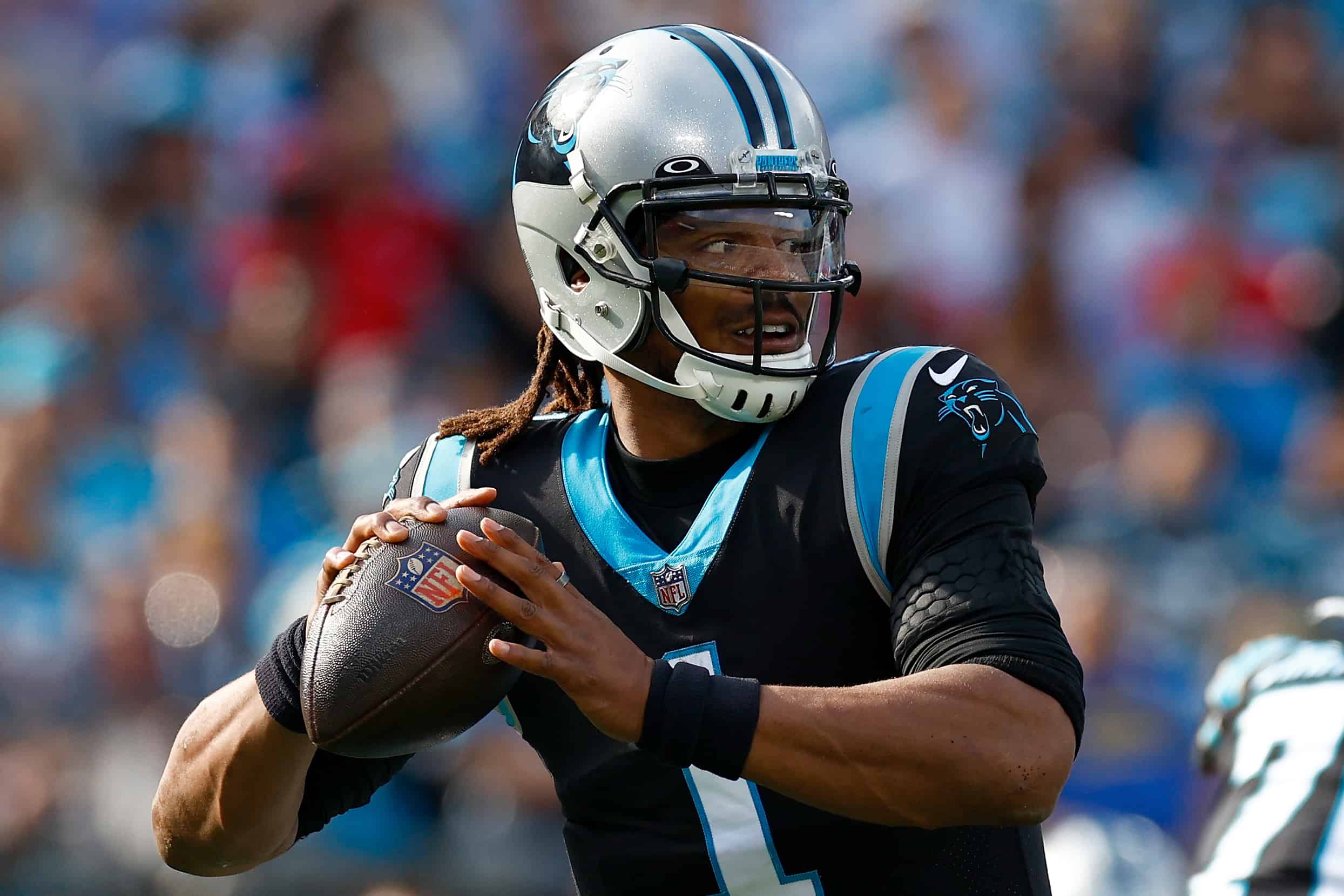 Cam Newton #1 of the Carolina Panthers drops back to pass the ball during the first quarter in the game against the Tampa Bay Buccaneers at Bank of America Stadium on December 26, 2021 in Charlotte, North Carolina.